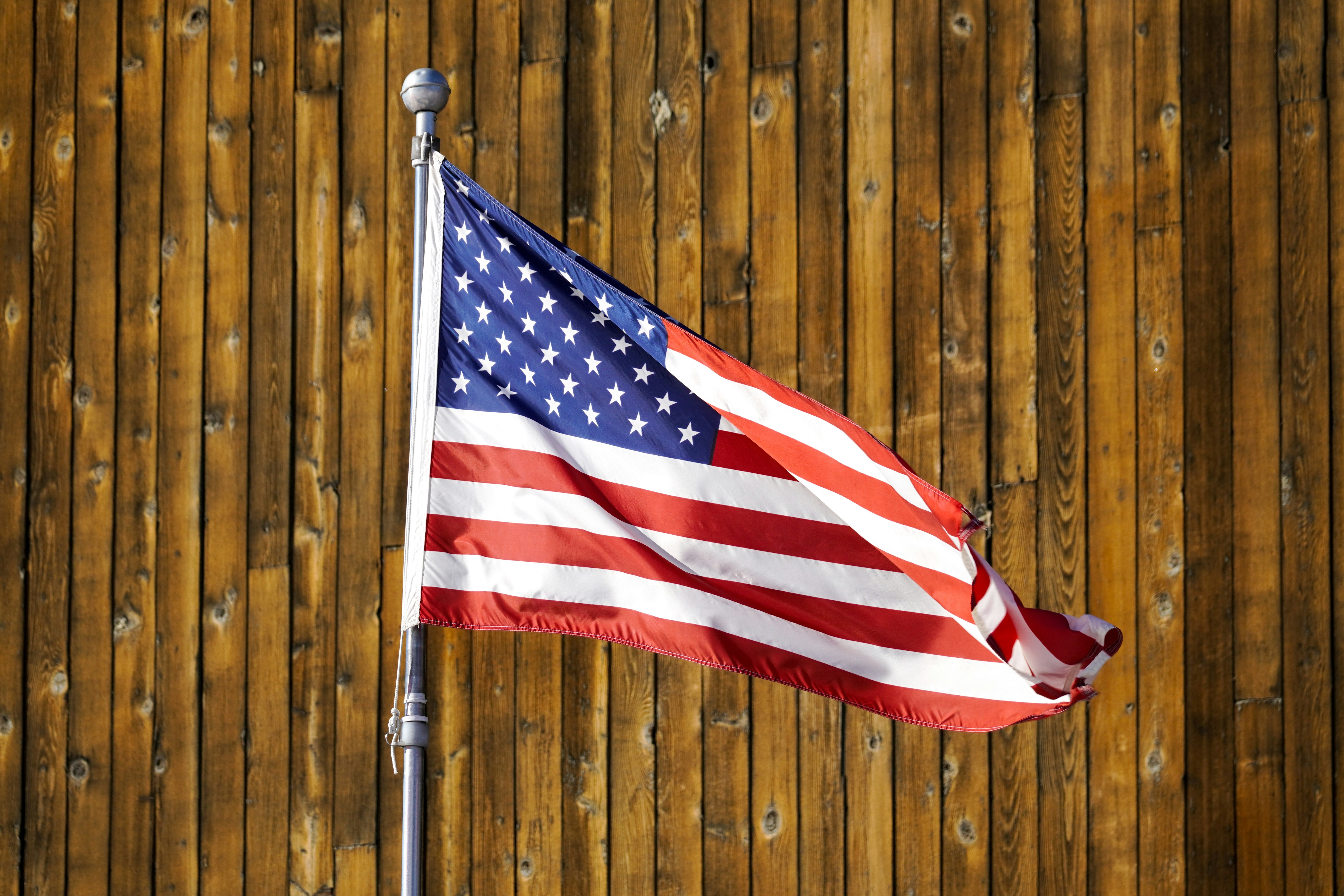 us a flag on brown wooden wall